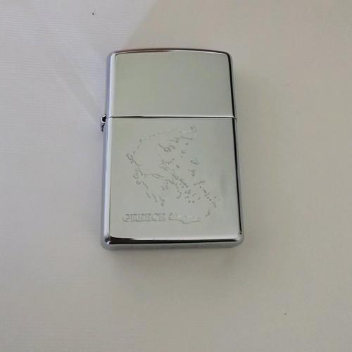 Zippo lighter used with engraved Greek map design
