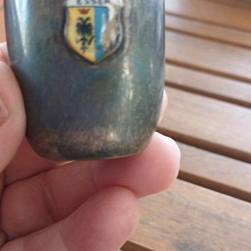 Silver shot glass used, with missing part on emblem