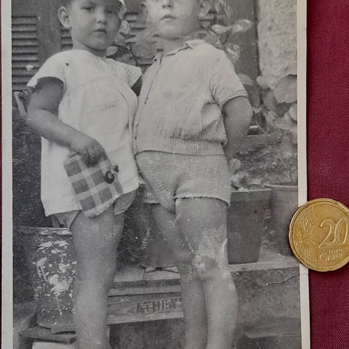 Vintage photo of two children on Athens courtyard steps, 1950s, used