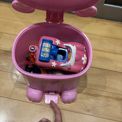 Pig-shaped kids bin used, filled with toys