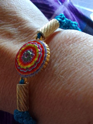 Handmade macrame bracelet with gold element and shiny blue cord