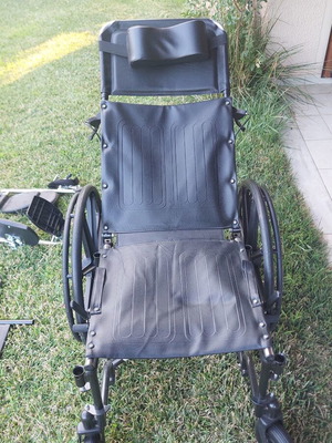 Wheelchair with adjustable reclining backrest and cushion