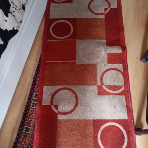 Vintage carpet runner used with geometric motifs in warm colors