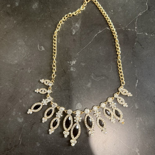 Women's gold necklace with black stones, used