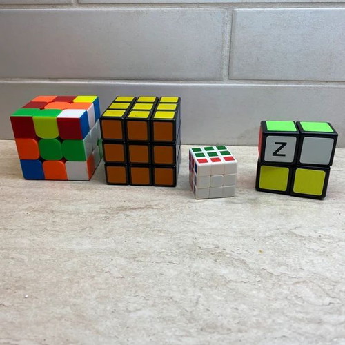Set of 4 cubes like new, including 3x3, 3x3 mini, and 2x1
