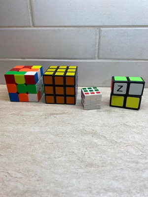 Set of 4 cubes like new, including 3x3, 3x3 mini, and 2x1