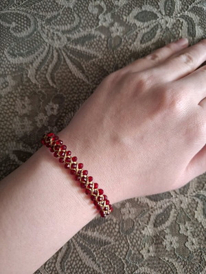 Macrame bracelet with burgundy beads and gold wax thread like new
