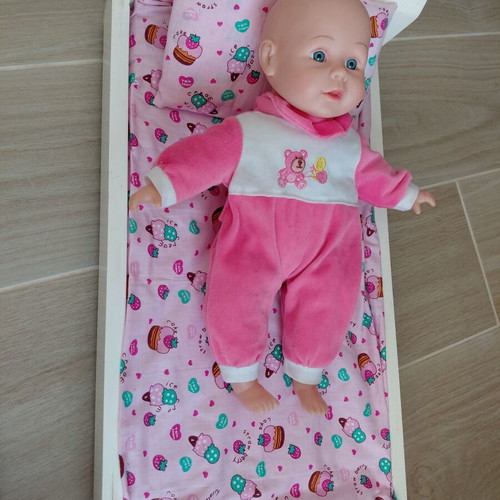 Doll bed with handmade bedding and doll used