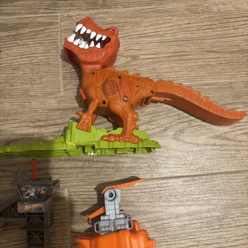 Hot Wheels track set pieces with T-Rex figure and launcher