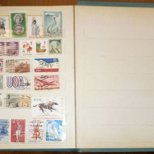 Book with collection of various Greek and foreign stamps used