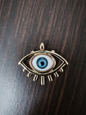 Eye motif pendant made of stainless steel, like new