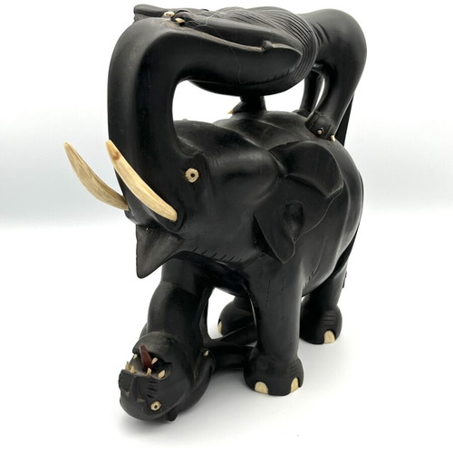 Vintage handmade ebony wood sculpture of elephant and lions