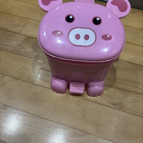 Pig-shaped kids bin used, filled with toys