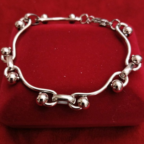 Stainless steel bracelet new, silver with intricate fastening