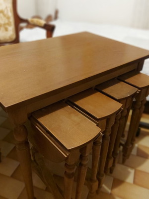 Rectangular table with 4 used round nesting tables