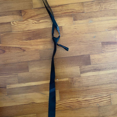 Leather thin black tie vintage used with fading marks