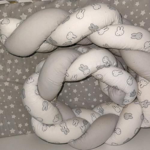 Baby braided crib bumper used in gray and white