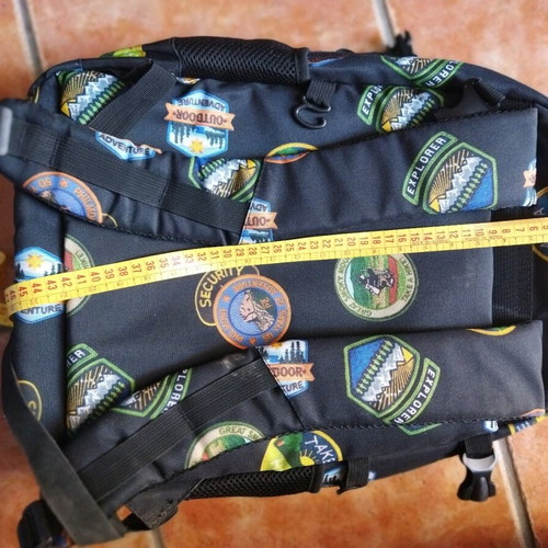 School backpack used with cut strap on the back