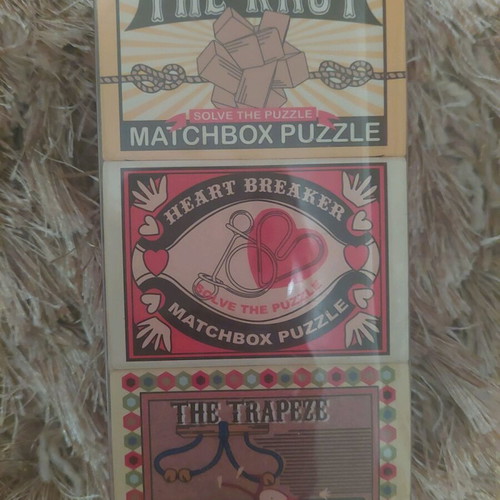 Matchbox puzzle set new with Heart, Knot, Trapeze