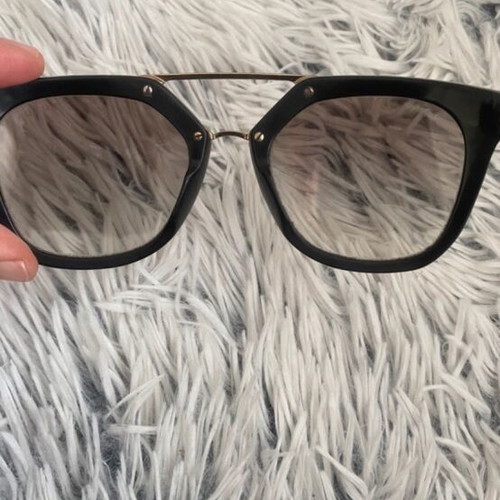Prada sunglasses in black with gold details