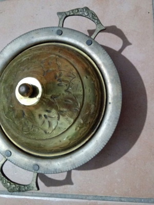 Traditional brass vessel used with decorative handles