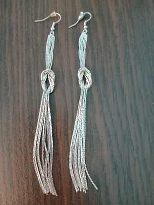 Long dangling earrings used, silver color