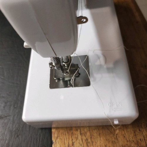 Mini sewing machine used with threads and battery operation