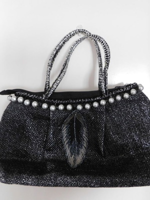 Handheld straw bag metallic like new with feather design and pearl accessory