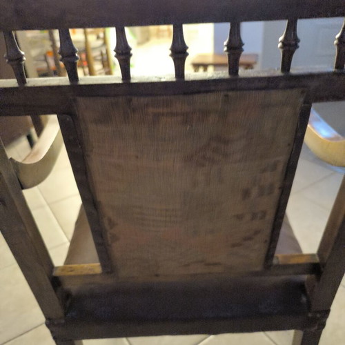 Vintage armchair refurbished with carved wood and leather backrest