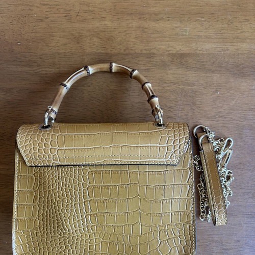 Yellow leather bag with bamboo strap