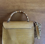 Yellow leather bag with bamboo strap