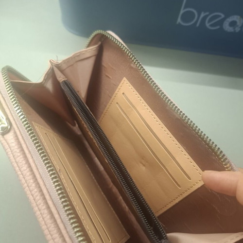 Pink wallet with strap and multiple compartments