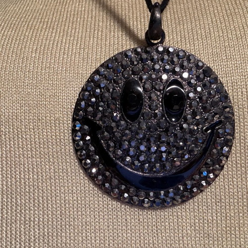 Long pendant like new with decorative emoji and black rhinestones