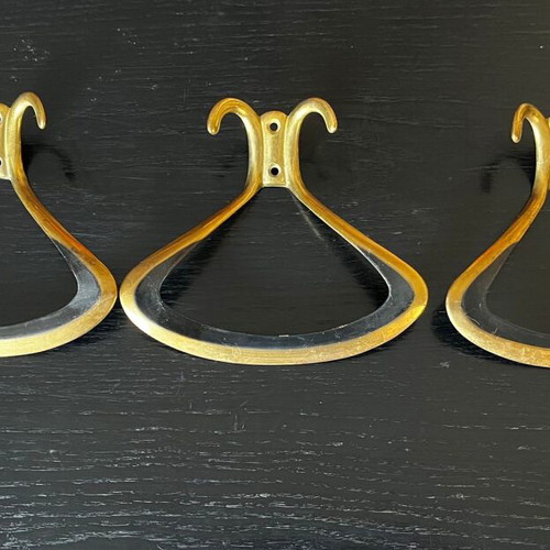 3 gold metal wall hooks