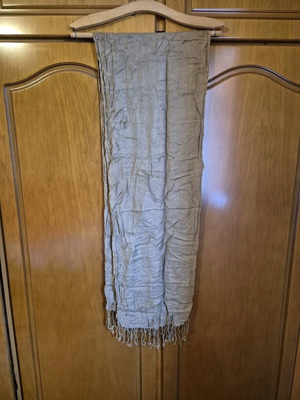 Scarf used in brown and beige tones with fringed edges