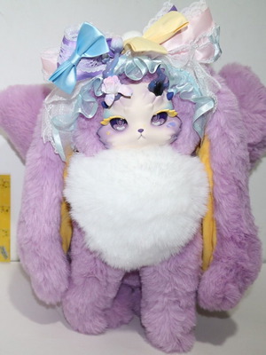 Plush fox toy with three tails, flower and bow