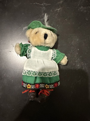 Small plush teddy bear with traditional costume used
