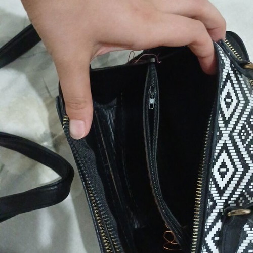 Black and white handbag with dual zipper and spacious interior