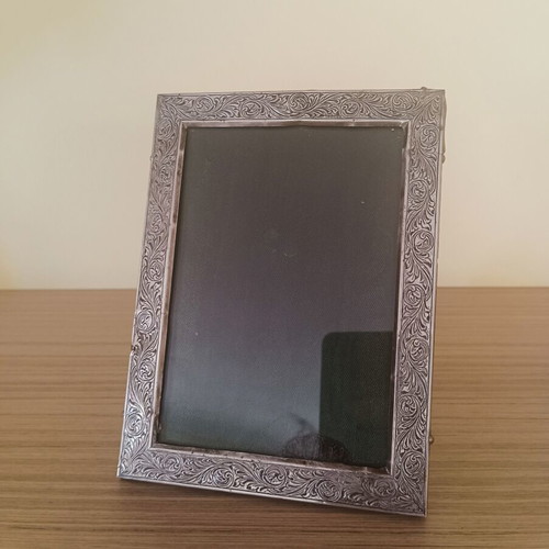Vintage ornate silver-plated photo frame with wooden back, used