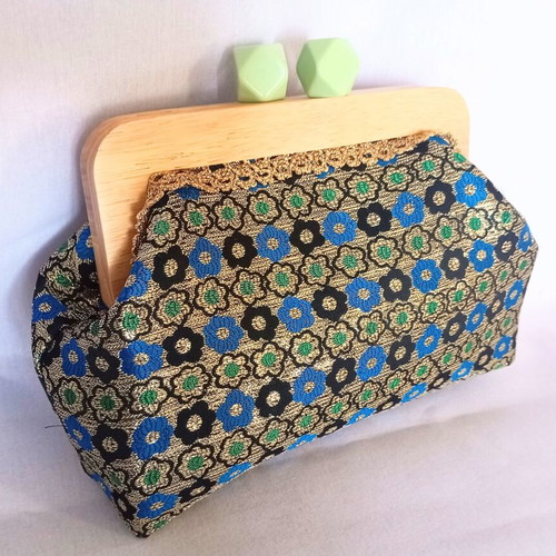 Handmade shoulder bag with traditional embroidery and wooden clasp