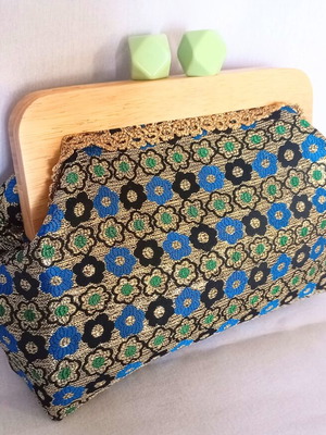 Handmade shoulder bag with traditional embroidery and wooden clasp
