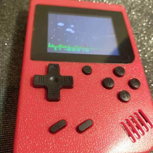 Retro style handheld game console used, working