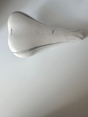 White bicycle saddle used with minor wear
