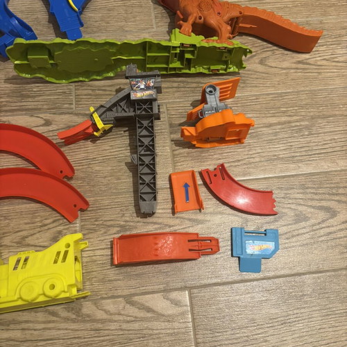 Hot Wheels track set pieces with T-Rex figure and launcher