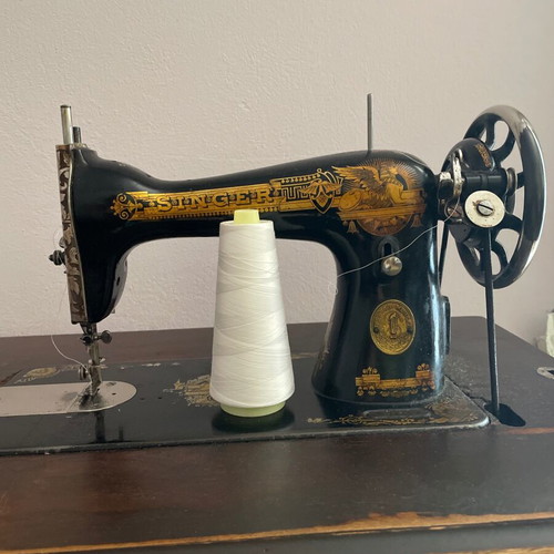 Singer 1960 foot-powered sewing machine used, wooden cover and table