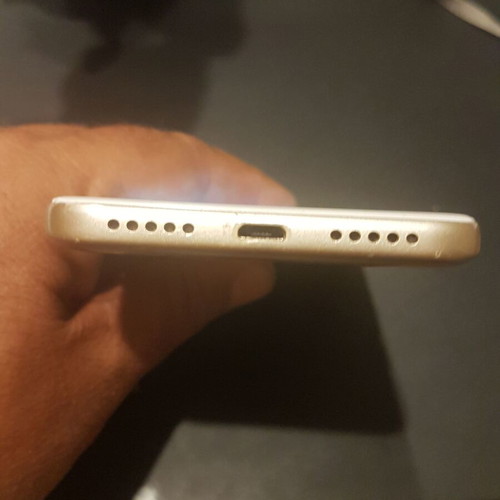 Xiaomi Redmi 4X smartphone with cracked screen, gold