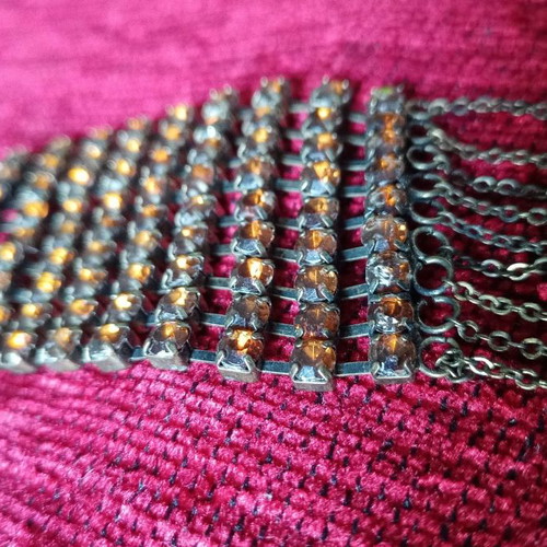 Alternative necklace used with rows of yellow crystals on antique bronze