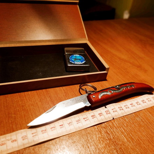 Collectible Zippo lighter 32 years old and handmade Okapi knife.
