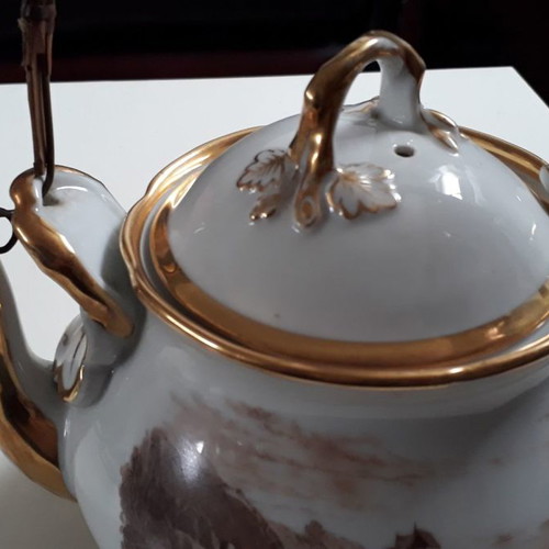 Antique porcelain teapot with wooden handle used
