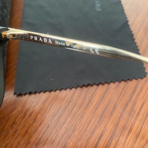 Prada sunglasses in black with gold details